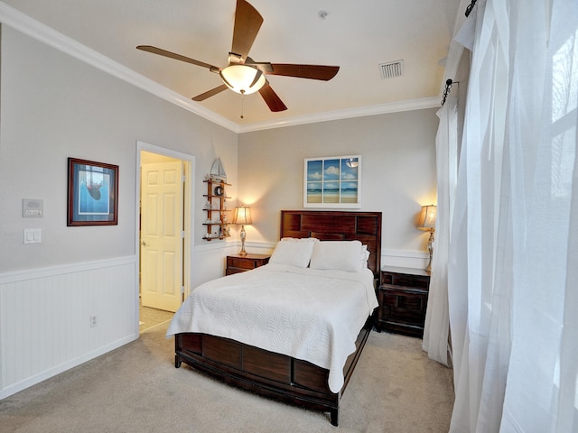 bedroom with ceiling fan, light colored carpet, and ornamental molding