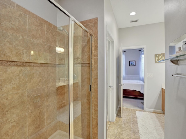 bathroom with tile patterned floors, vanity, and a shower with shower door