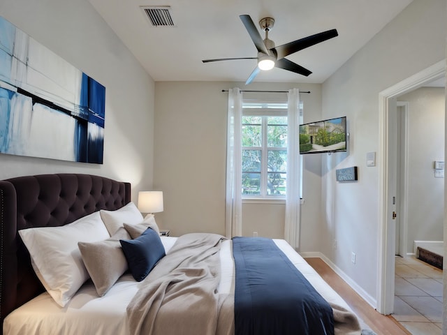 bedroom featuring light tile patterned floors and ceiling fan