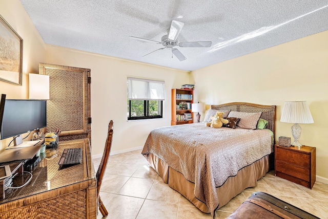 tiled bedroom featuring ceiling fan and a textured ceiling