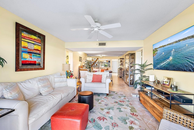 living room with ceiling fan and light tile patterned floors