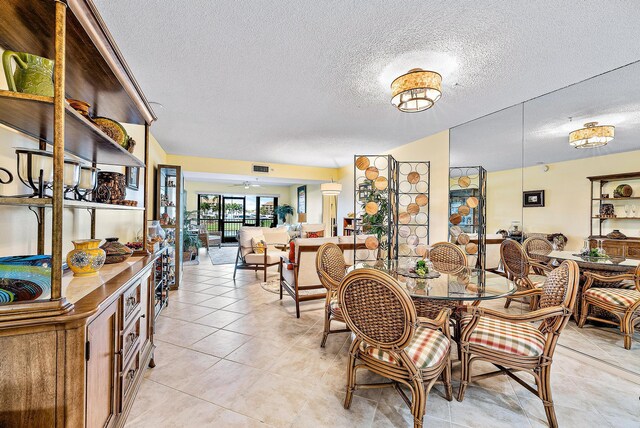 tiled dining room featuring a textured ceiling