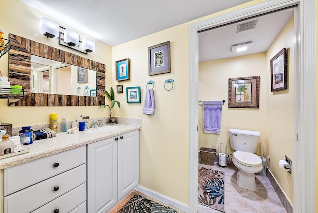 bathroom with vanity, toilet, and tile flooring