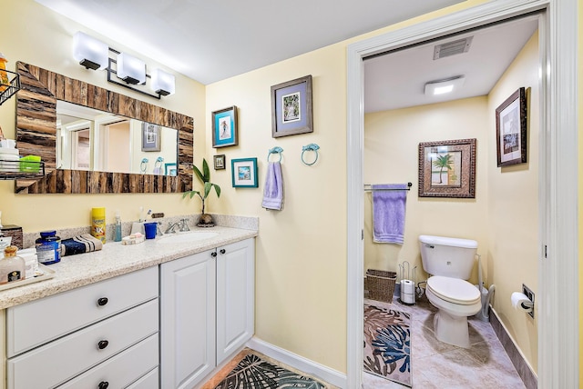 bathroom with vanity, tile patterned flooring, and toilet