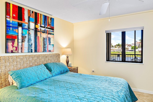 bedroom featuring crown molding, ceiling fan, and a textured ceiling