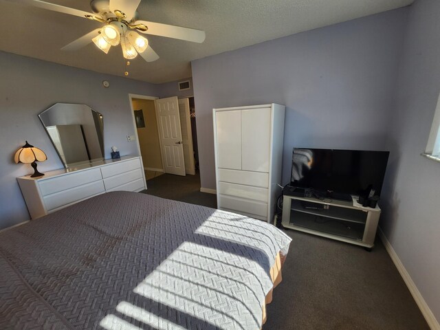 bedroom with dark colored carpet and ceiling fan