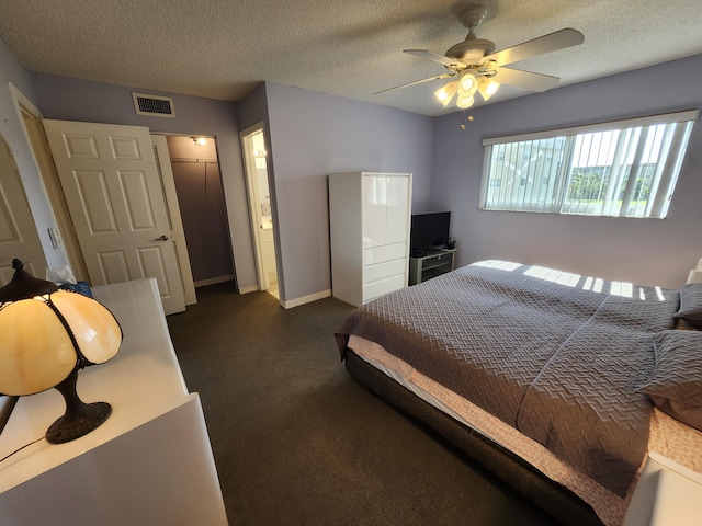 bedroom featuring connected bathroom, ceiling fan, a closet, and a textured ceiling