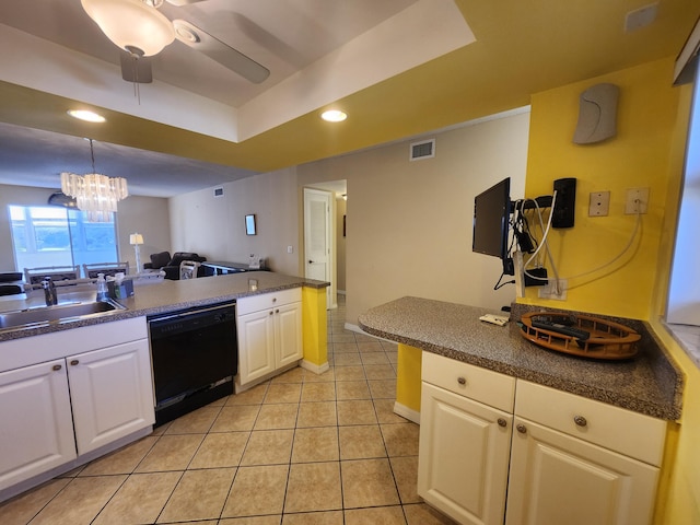 kitchen with ceiling fan with notable chandelier, a tray ceiling, sink, white cabinets, and black dishwasher