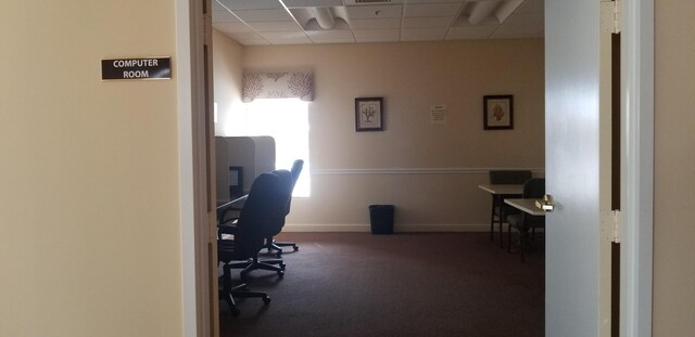 office space with a paneled ceiling