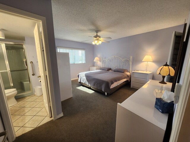 tiled bedroom with ensuite bath, ceiling fan, and a textured ceiling