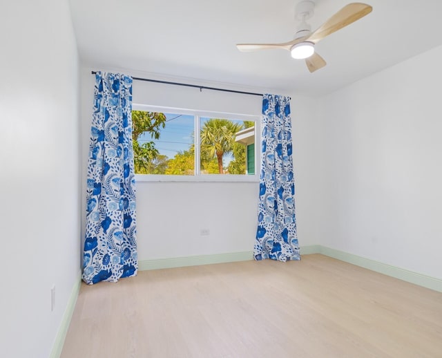 spare room featuring light hardwood / wood-style flooring and ceiling fan