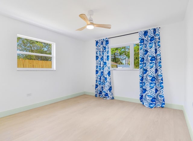 spare room featuring ceiling fan and light hardwood / wood-style floors