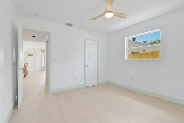 spare room with light hardwood / wood-style flooring and ceiling fan