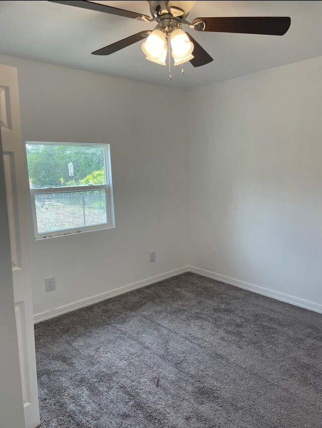 empty room with ceiling fan and carpet floors