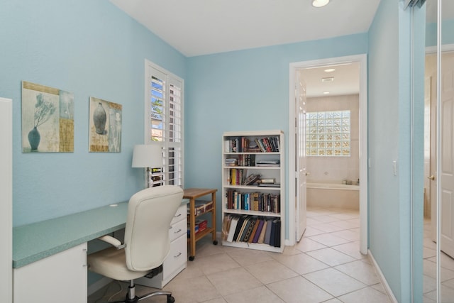 office space featuring a wealth of natural light and light tile flooring