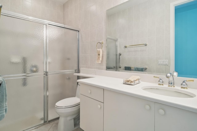 bathroom featuring an enclosed shower, vanity, tile floors, and toilet