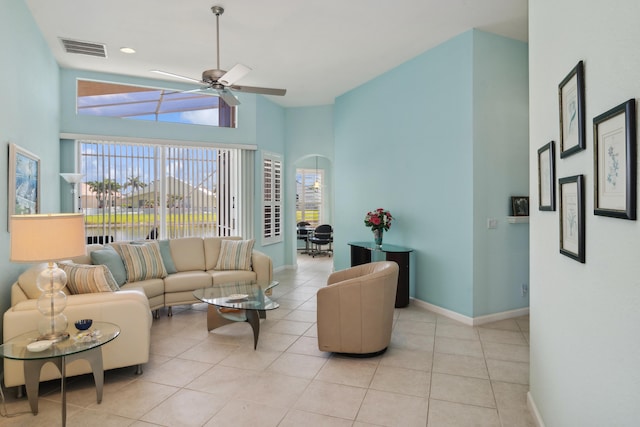 living room with ceiling fan, a healthy amount of sunlight, and light tile floors