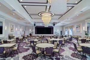 dining space featuring coffered ceiling and beamed ceiling