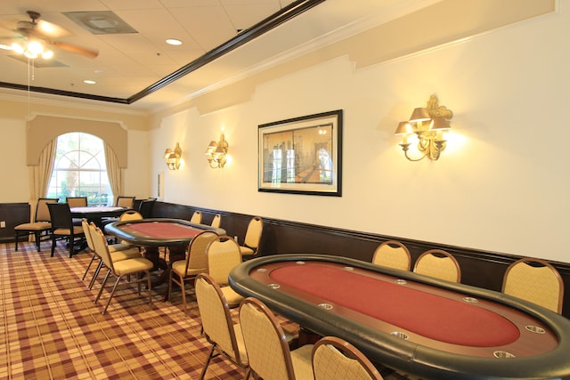 playroom featuring ornamental molding, ceiling fan, and a tray ceiling