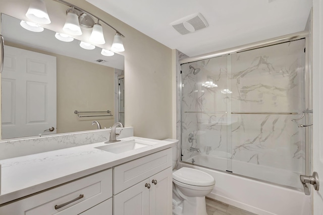 full bathroom with vanity with extensive cabinet space, toilet, and bath / shower combo with glass door