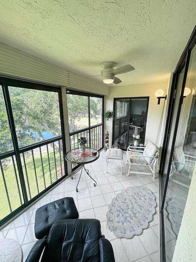 sunroom / solarium with plenty of natural light and ceiling fan