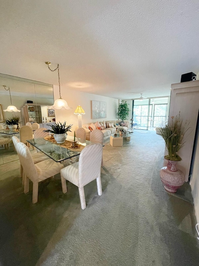 carpeted dining room featuring a textured ceiling