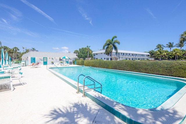 view of swimming pool with a patio