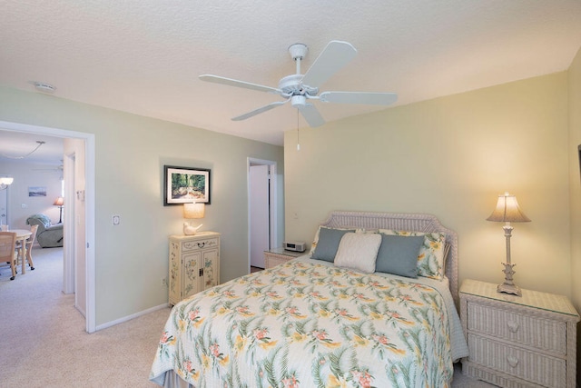 bedroom featuring light colored carpet and ceiling fan