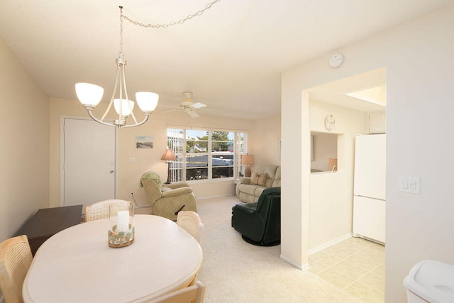 dining space with ceiling fan with notable chandelier