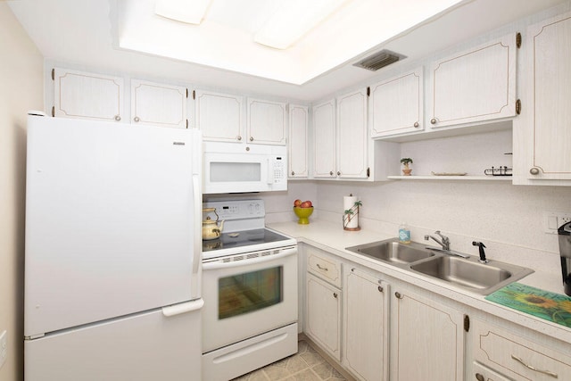 kitchen with white cabinets, white appliances, and sink