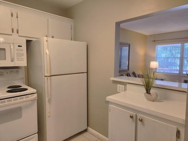 kitchen featuring white cabinets, white appliances, and light tile patterned floors