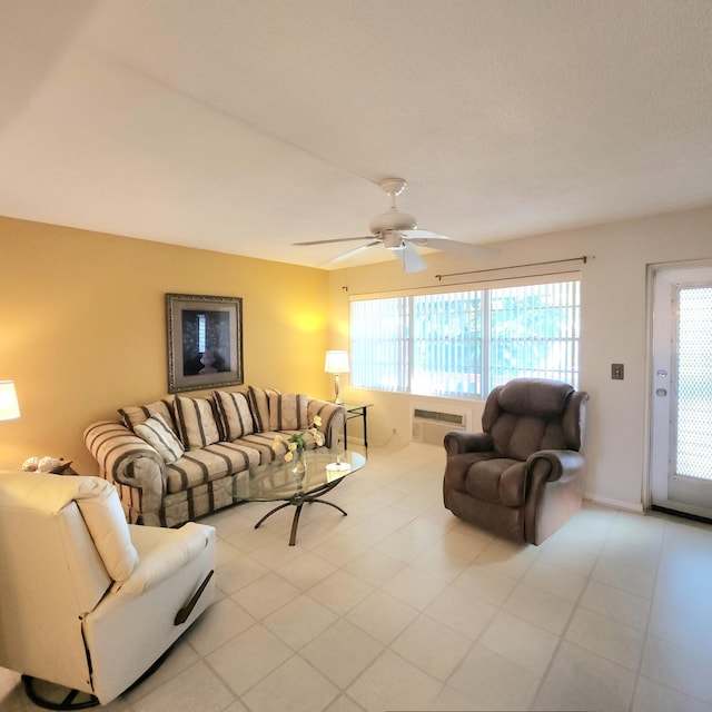 living room with an AC wall unit and ceiling fan