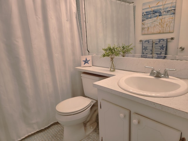 bathroom featuring tile patterned floors, vanity, and toilet