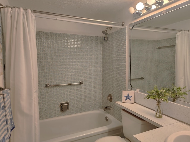 full bathroom with vanity, toilet, shower / bath combo with shower curtain, and a textured ceiling