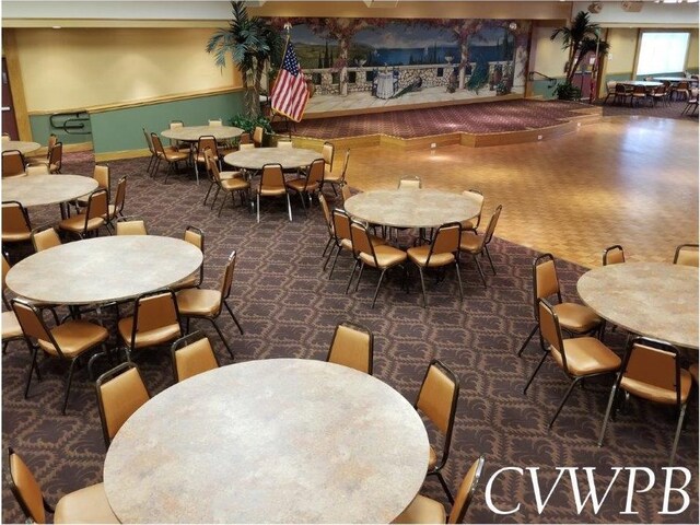 dining space featuring dark carpet