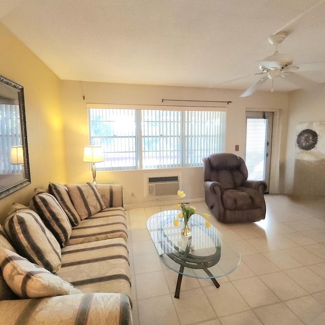 tiled living room with a textured ceiling, an AC wall unit, and ceiling fan