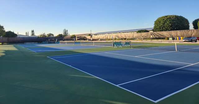 view of tennis court featuring basketball court