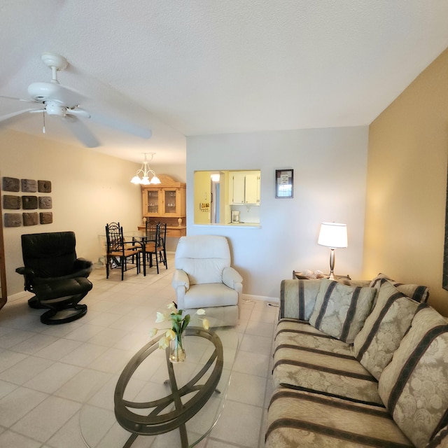 living room featuring ceiling fan with notable chandelier