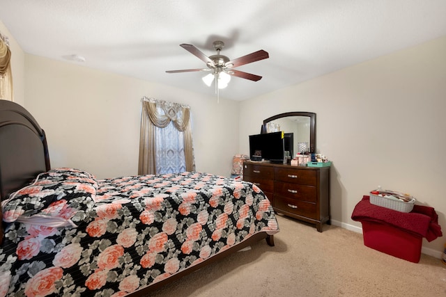 bedroom with ceiling fan and light carpet