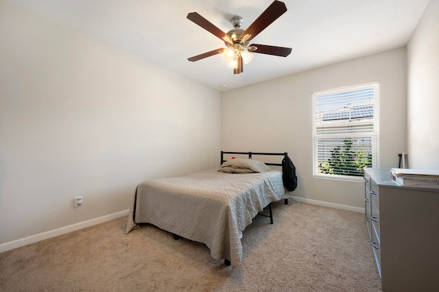 bedroom featuring light carpet and ceiling fan