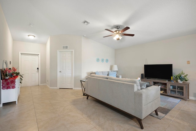 tiled living room with ceiling fan