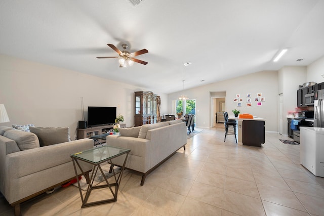 living room with lofted ceiling, ceiling fan with notable chandelier, and light tile floors