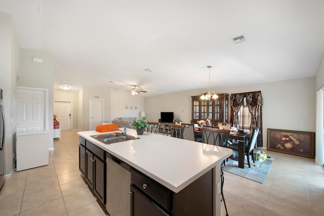 kitchen with ceiling fan with notable chandelier, a kitchen island with sink, sink, pendant lighting, and stainless steel dishwasher