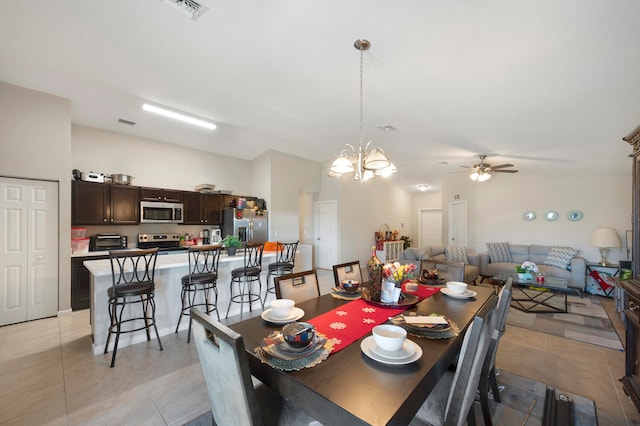 dining area featuring ceiling fan with notable chandelier and light tile floors