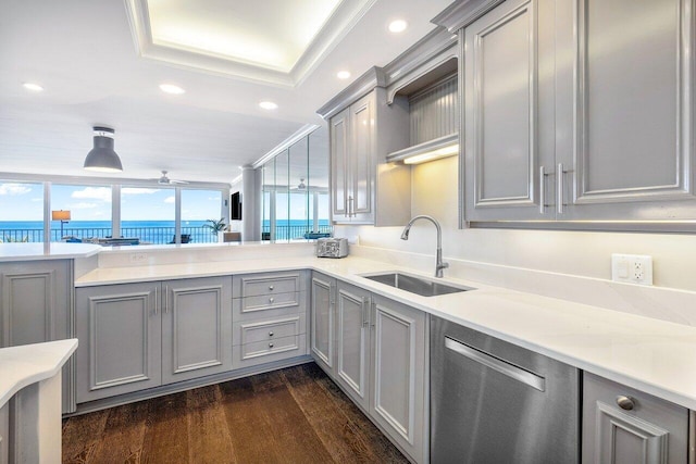 kitchen featuring gray cabinets, dark wood-type flooring, a water view, sink, and dishwasher