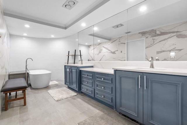 bathroom with tile walls, ornamental molding, double vanity, a bathing tub, and tile flooring