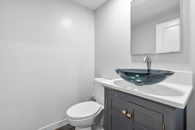 bathroom featuring toilet and vanity