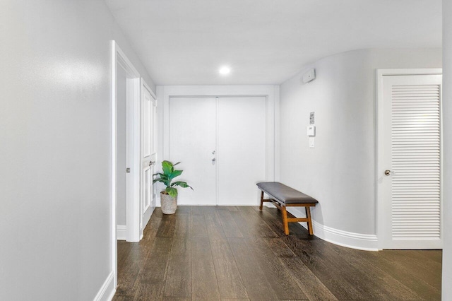 hallway with dark hardwood / wood-style floors