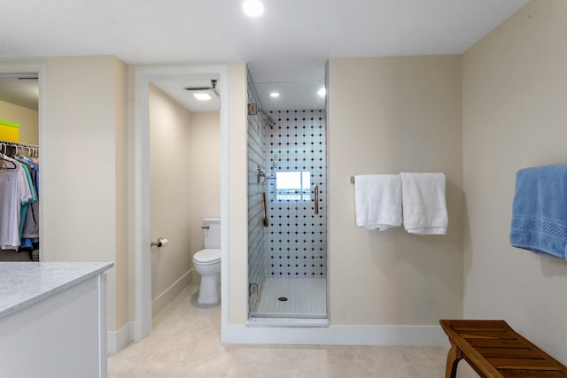 bathroom with tile patterned flooring, walk in shower, toilet, and vanity