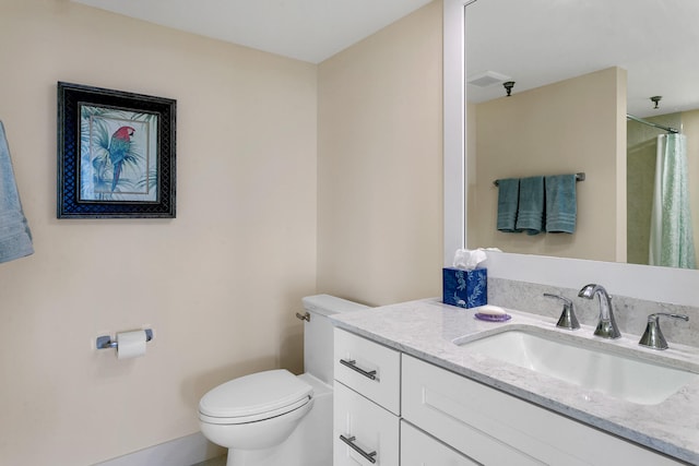 bathroom with vanity, toilet, and walk in shower